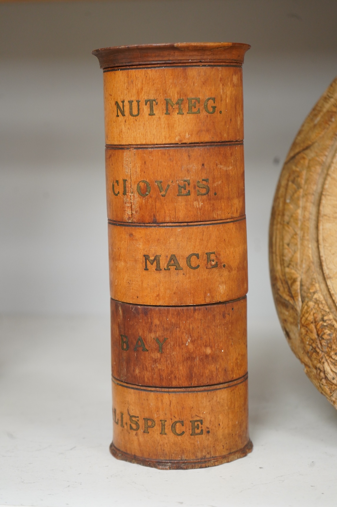 A Victorian treen spice tower and a carved bread board, 30cm in diameter